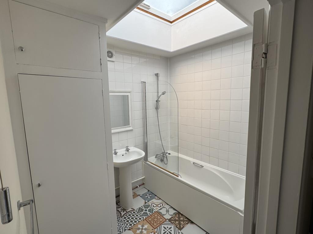 Lot: 152 - TWO-BEDROOM TOWN CENTRE FLAT FOR INVESTMENT OR OWNER OCCUPATION - Bath and hand basin with skylight